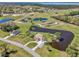 Beautiful aerial view of a home with a long driveway surrounded by a lovely pond and green landscape at 3607 Hidden River Ln, Tavares, FL 32778