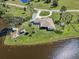 Aerial view of the property, highlighting the lakefront location, manicured lawn, and outdoor amenities at 3607 Hidden River Ln, Tavares, FL 32778