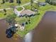 Expansive waterfront property with a meticulously maintained lawn, outdoor fire pit, and mature trees at 3607 Hidden River Ln, Tavares, FL 32778