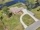 Stunning aerial view of a sprawling property with a well-maintained home, lush landscaping, and a serene pond at 3607 Hidden River Ln, Tavares, FL 32778