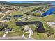 Stunning aerial view of a home with a long driveway and beautiful pond and lake access at 3607 Hidden River Ln, Tavares, FL 32778