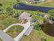 Stunning aerial view of a lakeside property with lush landscaping and a private gazebo at 3607 Hidden River Ln, Tavares, FL 32778