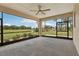 Enclosed back porch with ceiling fan and serene view of the backyard at 3607 Hidden River Ln, Tavares, FL 32778