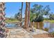 Picturesque view of backyard leading to a peaceful pond with natural landscaping at 3607 Hidden River Ln, Tavares, FL 32778