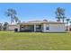 Spacious backyard with lush green grass and a covered patio perfect for entertaining at 3607 Hidden River Ln, Tavares, FL 32778