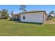 Exterior view of a single-story home with a well-manicured lawn and screened-in patio at 3607 Hidden River Ln, Tavares, FL 32778