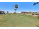 Large backyard with a pond in the distance and covered wooden pergola at 3607 Hidden River Ln, Tavares, FL 32778