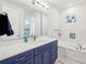 Stylish bathroom with a double sink vanity, modern fixtures, and a separate bathtub at 3607 Hidden River Ln, Tavares, FL 32778