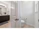 A half bathroom featuring a toilet and a sink, and tiled floors at 3607 Hidden River Ln, Tavares, FL 32778