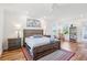 Serene bedroom with hardwood floors, scenic views, and a rustic wooden bed frame at 3607 Hidden River Ln, Tavares, FL 32778