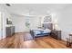 Bright bedroom with wood floors, ceiling fan, and a rustic-chic wooden bed frame at 3607 Hidden River Ln, Tavares, FL 32778