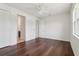 Bright bedroom features sleek, dark hardwood floors and closet space at 3607 Hidden River Ln, Tavares, FL 32778