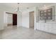 Open dining area with white cabinetry and tile flooring, offering a versatile space for meals and entertaining at 3607 Hidden River Ln, Tavares, FL 32778
