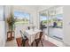 Inviting dining area with sliding glass doors to outdoor patio with a lake view at 3607 Hidden River Ln, Tavares, FL 32778