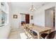 Bright dining room features a wood table and view into the living room through a sliding barn door at 3607 Hidden River Ln, Tavares, FL 32778