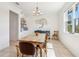 Bright dining room features a wood table, chandelier, and a decorative tree on the wall at 3607 Hidden River Ln, Tavares, FL 32778