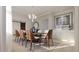 An inviting dining room featuring stylish chairs, modern lighting, and a chic accent wall with a mirrored decor piece at 3607 Hidden River Ln, Tavares, FL 32778