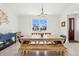 Bright dining room features a wood table, bench seating, and a view from the window at 3607 Hidden River Ln, Tavares, FL 32778