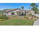 Well-maintained home boasts stone accents, mature landscaping and a circular driveway at 3607 Hidden River Ln, Tavares, FL 32778