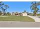 Beautiful single-Gathering home with a circular driveway, well-maintained lawn, and mature trees at 3607 Hidden River Ln, Tavares, FL 32778