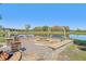 Beautiful fire pit area with a swing, pond views, and ample seating for outdoor gatherings at 3607 Hidden River Ln, Tavares, FL 32778