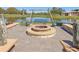 Inviting outdoor fire pit area with swing and views of the pond for relaxing evenings at 3607 Hidden River Ln, Tavares, FL 32778