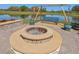 Wonderful fire pit with pond views, swing, and ample seating for outdoor fun at 3607 Hidden River Ln, Tavares, FL 32778