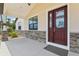 Charming front entrance with decorative glass double doors and stone accents at 3607 Hidden River Ln, Tavares, FL 32778