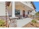 Charming front porch with stone pillars, a hanging plant, and a cozy rocking chair at 3607 Hidden River Ln, Tavares, FL 32778