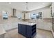 Open kitchen with island, stainless appliances, and white cabinets at 3607 Hidden River Ln, Tavares, FL 32778