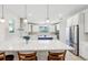 Bright kitchen with stainless appliances, white cabinets, an island with barstool seating and a blue accent island at 3607 Hidden River Ln, Tavares, FL 32778