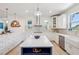 Bright, modern kitchen with white cabinets, quartz countertops, and stainless steel appliances at 3607 Hidden River Ln, Tavares, FL 32778