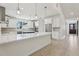 Bright and spacious kitchen featuring a large island, stainless steel appliances, and ample cabinet space at 3607 Hidden River Ln, Tavares, FL 32778
