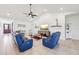 Open living room with vaulted ceilings, neutral color palette, tile floors, and comfortable seating at 3607 Hidden River Ln, Tavares, FL 32778