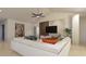 Open living room with vaulted ceilings and a modern TV wall, featuring comfortable seating and stylish decor at 3607 Hidden River Ln, Tavares, FL 32778