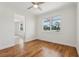 Bright living room with hardwood floors, a ceiling fan, and a large window showcasing the outdoors at 3607 Hidden River Ln, Tavares, FL 32778