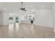Open-concept living space showcasing tile flooring, with view to the kitchen and a large sliding glass door to the backyard at 3607 Hidden River Ln, Tavares, FL 32778