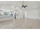 Open-concept living room features modern lighting, neutral color palette, and flows seamlessly into the updated kitchen at 3607 Hidden River Ln, Tavares, FL 32778