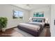Modern bedroom featuring neutral tones, an area rug, and views from the window at 3607 Hidden River Ln, Tavares, FL 32778