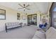 Covered patio with ceiling fan, comfortable seating, and mounted television at 3607 Hidden River Ln, Tavares, FL 32778