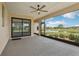 Screened patio with ceiling fan overlooking lake at 3607 Hidden River Ln, Tavares, FL 32778