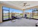 Relaxing screened-in patio overlooking a serene lake, complete with comfortable seating and a ceiling fan at 3607 Hidden River Ln, Tavares, FL 32778