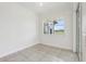 Bright room featuring neutral tile floors and a window with a view of the outside; sliding glass door at 3607 Hidden River Ln, Tavares, FL 32778