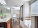 Bathroom leading to a bedroom, featuring double sinks and a soaking tub at 3709 Cedar Hammock Trl, St Cloud, FL 34772