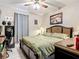 Comfortable bedroom featuring a ceiling fan, artwork, and an earth-tone color scheme at 3709 Cedar Hammock Trl, St Cloud, FL 34772