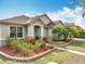 Well-kept home with a lovely yard, mulched flower beds, and attractive landscaping in a suburban neighborhood at 3709 Cedar Hammock Trl, St Cloud, FL 34772