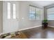 Inviting foyer with decorative front door, tile and hardwood flooring, and ample natural light from nearby windows at 3709 Cedar Hammock Trl, St Cloud, FL 34772