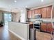 A kitchen with stainless steel appliances, modern cabinets, and access to outdoor patio at 3709 Cedar Hammock Trl, St Cloud, FL 34772