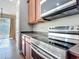 Stainless steel oven and range top with granite countertops and wooden cabinets in this kitchen at 3709 Cedar Hammock Trl, St Cloud, FL 34772