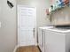 Functional laundry room with modern washer and dryer units, plus storage shelves at 3709 Cedar Hammock Trl, St Cloud, FL 34772